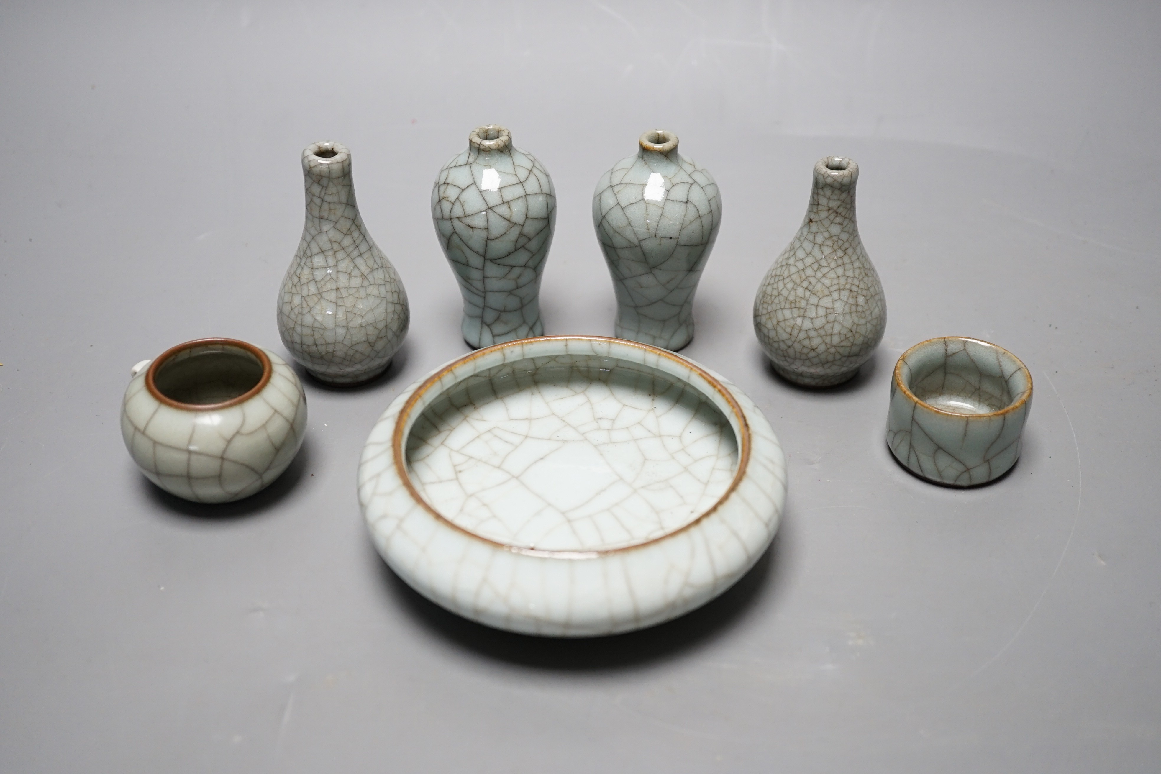 Seven Chinese Guan-type crackle glaze vessels one with four character mark, largest 11cm diameter